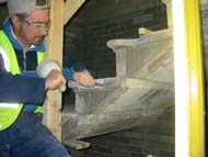 Stonemason repairing the stairs. Photo by Sapcote. Select the image or caption to see a larger image.